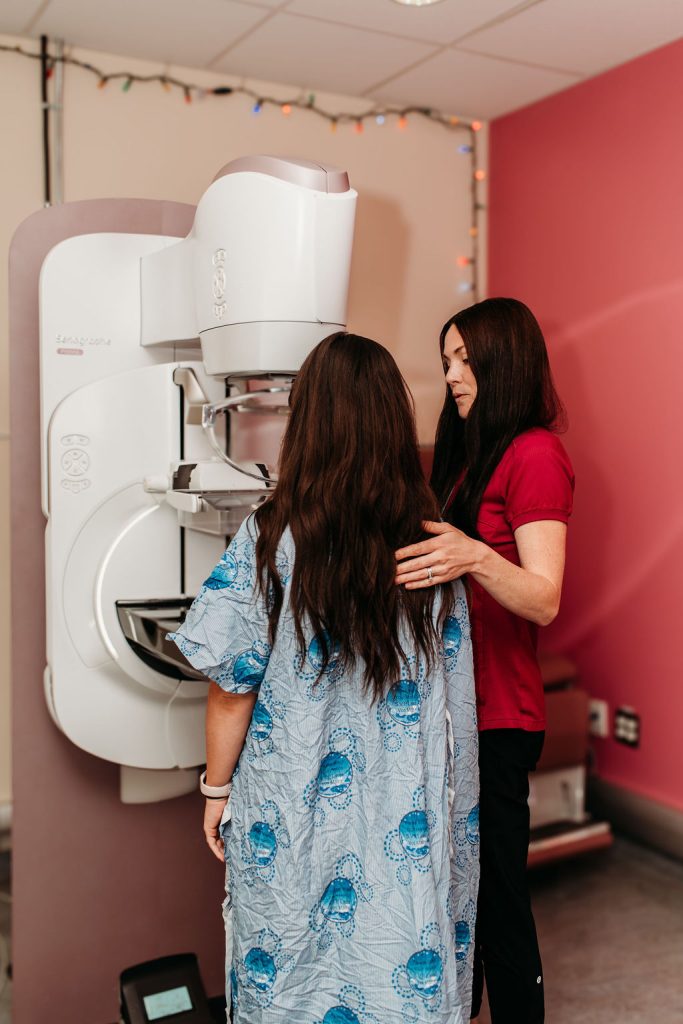 Mammogram being performed at Queensway Carleton Hospital Mammography Machine with Mammography Technician and Woman Being Screened